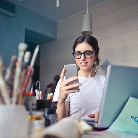 Woman at work looking at her Smartphone